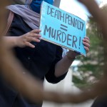 An activist holds a sign against the death penalty in Kuala Lumpur, Malaysia.
