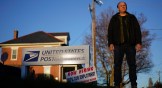 Gerald Groff, a former postal worker whose case will be argued before the Supreme Court, stands during a television interview near a "Now Hiring" sign posted at the roadside at the United State Postal Service.