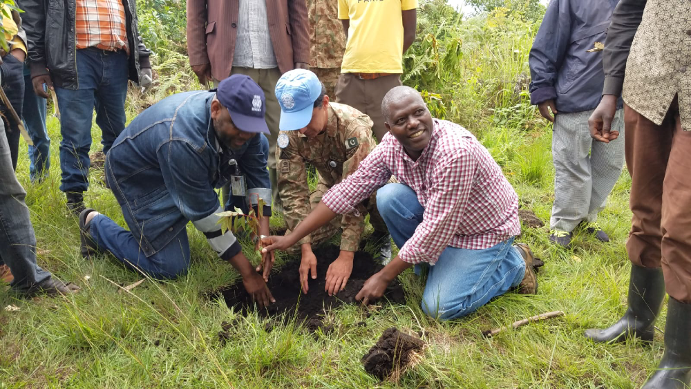 Lazare Sebitereko Rukundwa plants a tree in the Democratic Republic of Congo.