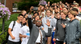 Warner Pacific University president Brian Johnson takes a selfie with college students.