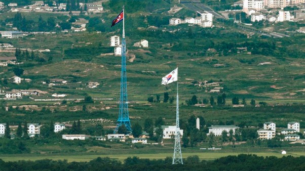 Flags of North Korea, rear, and South Korea, front, flutter in the wind as pictured from the border area between two Koreas.