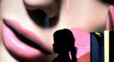A woman walks past a promotional billboard at a shopping mall in Jakarta, Indonesia.