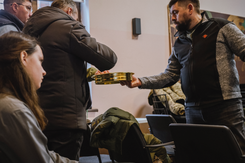 Evangelical ministers serve each other communion at a conference for volunteer chaplains.