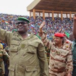 Mohamed Toumba (second to left), one of the leading figures of the National Council for the Protection of the Fatherland, greets coup supporters at a stadium in Niamey, the capital of Niger.