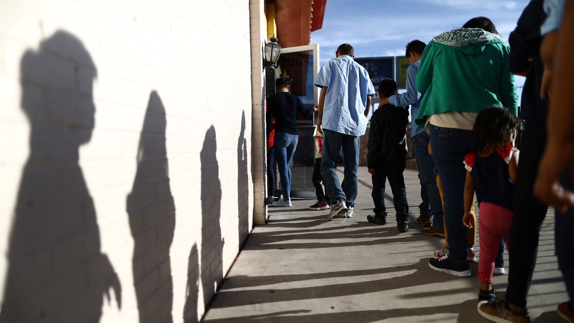 Recently arrived migrants from Central America line up to receive dinner at a church shelter for migrants who are seeking asylum in El Paso, Texas.