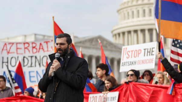 A religious official leads a prayer during a protest organized by the Armenian National Committee of America outside of the U.S. Capitol.