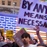 A protester holds up a sign at the All Out for Palestine rally in Times Square.