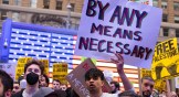 A protester holds up a sign at the All Out for Palestine rally in Times Square.