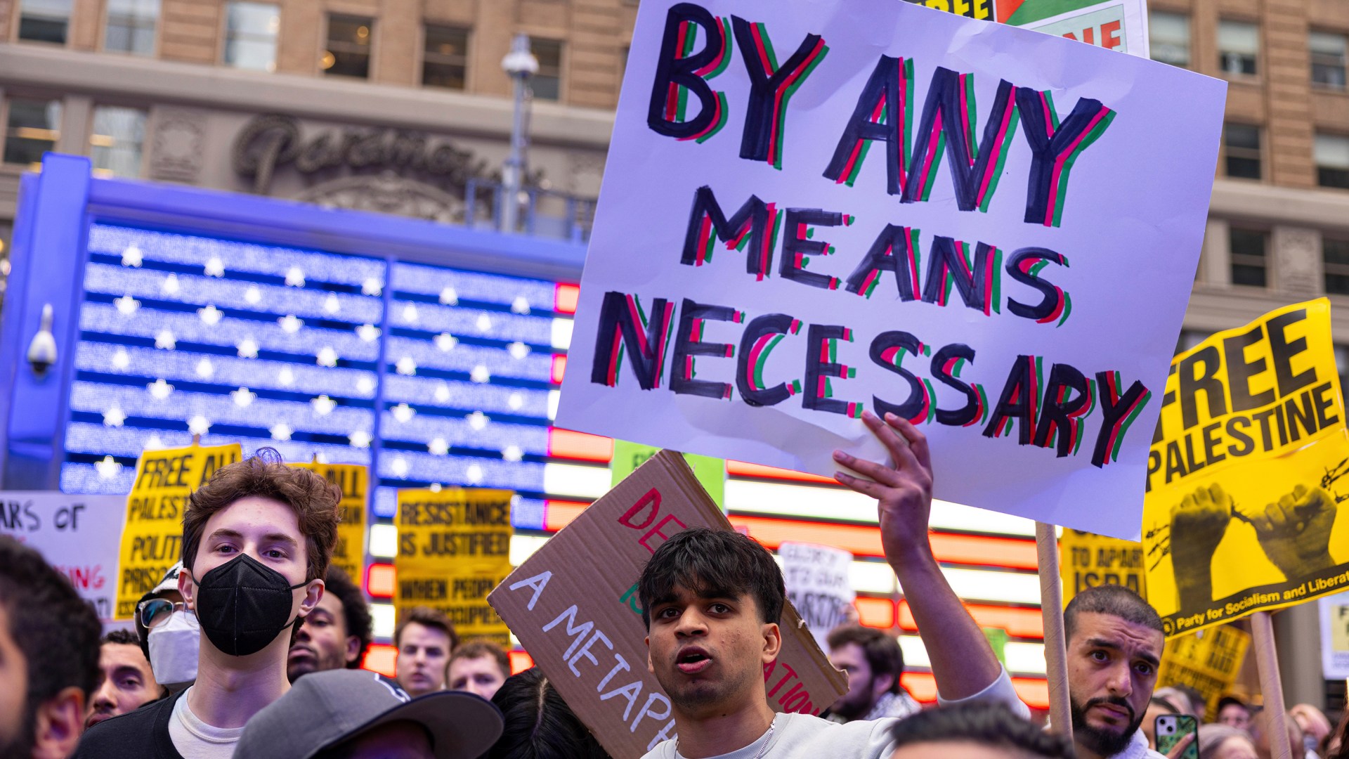 A protester holds up a sign at the All Out for Palestine rally in Times Square.