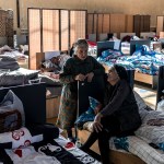 Two displaced women from Nagorno Karabakh talk at a temporary shelter in Armenia.