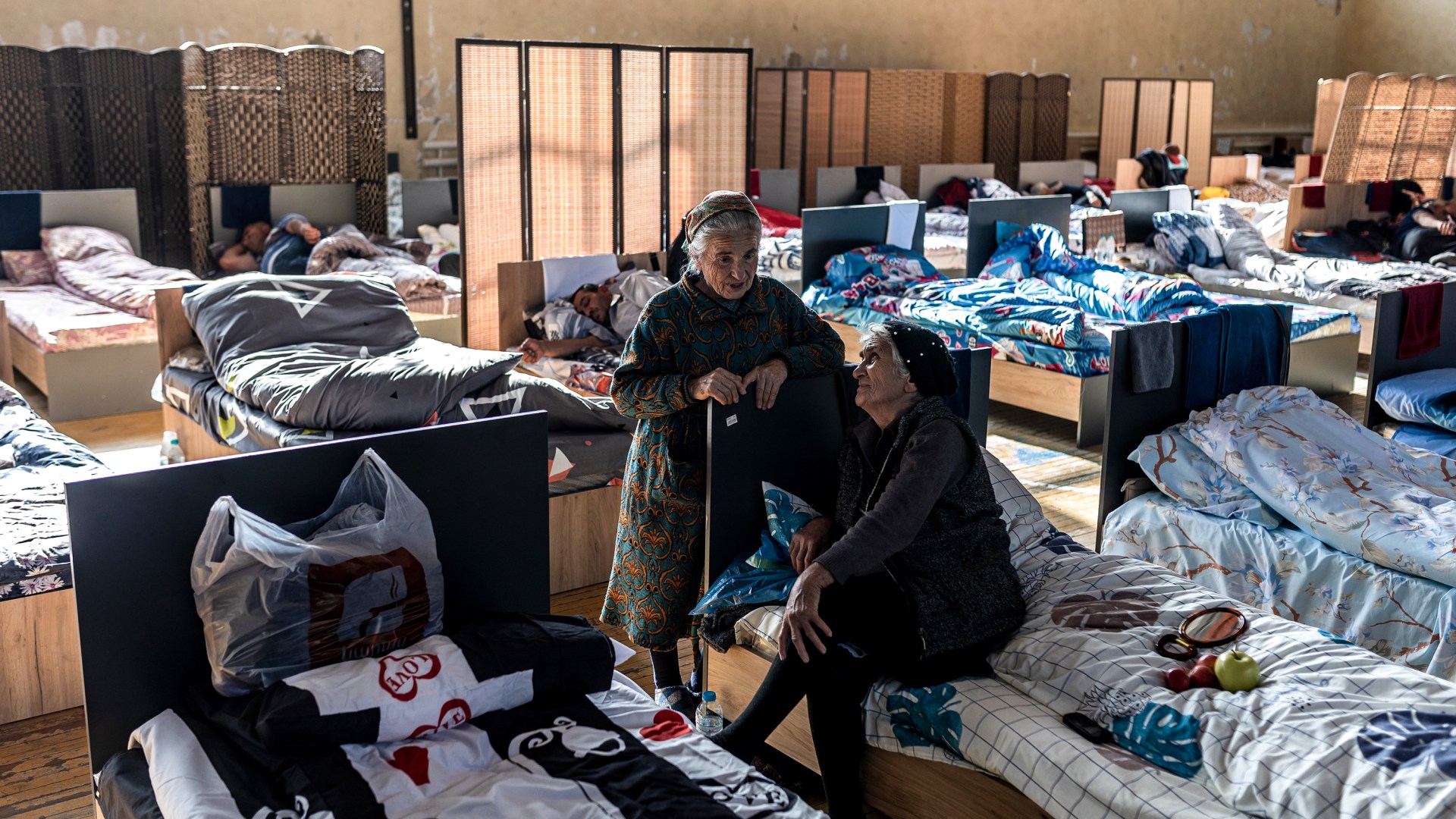 Two displaced women from Nagorno Karabakh talk at a temporary shelter in Armenia.