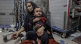 An injured mother and son taken to Al-Shifa Hospital following an explosion at Al-Ahli Hospital in Gaza.