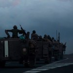 Israeli armored personnel carriers move in formation near the border with Lebanon.
