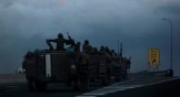 Israeli armored personnel carriers move in formation near the border with Lebanon.