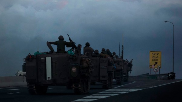 Israeli armored personnel carriers move in formation near the border with Lebanon.