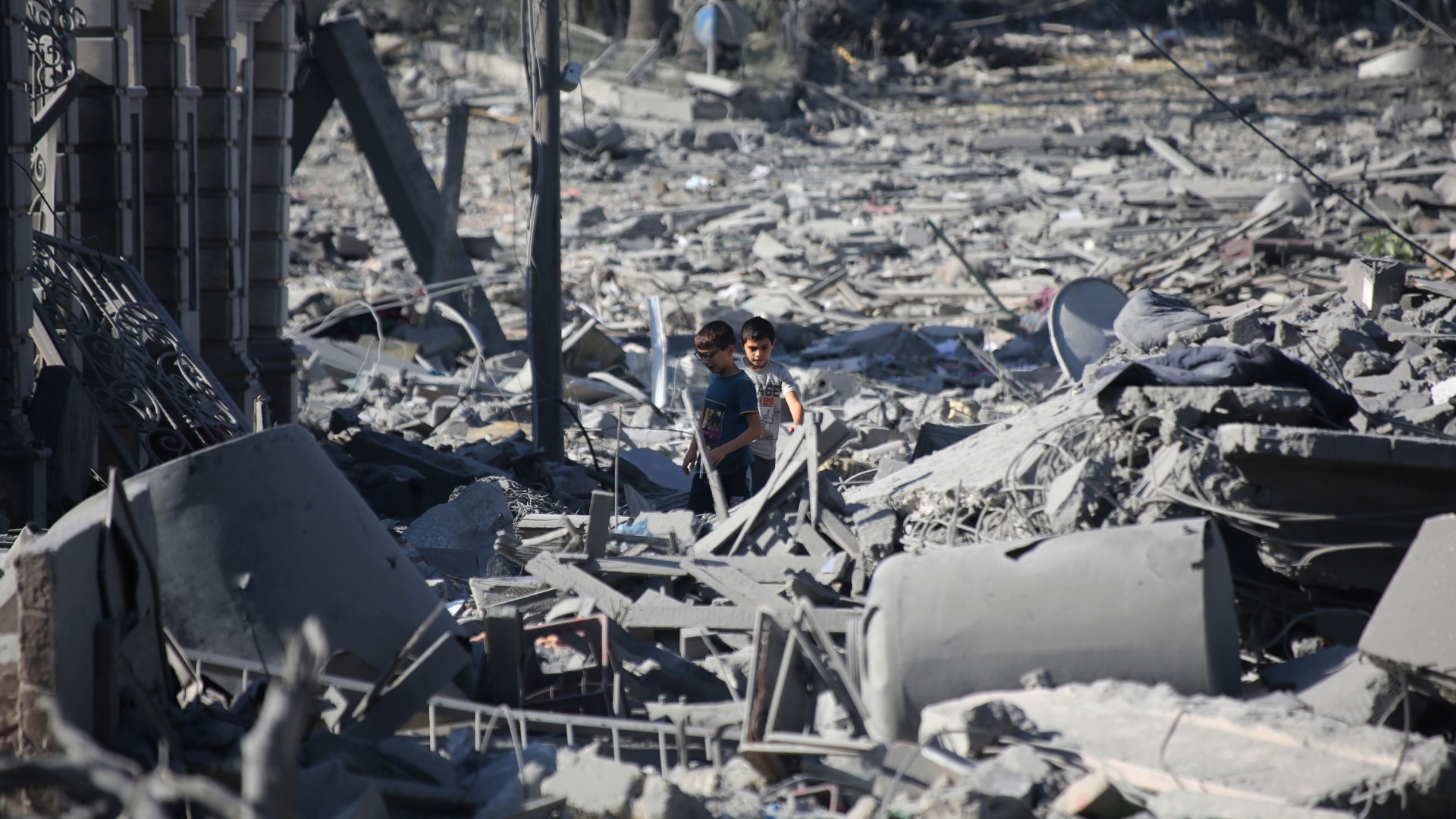 Palestinian children inspect damage to their homes caused by Israeli airstrikes.