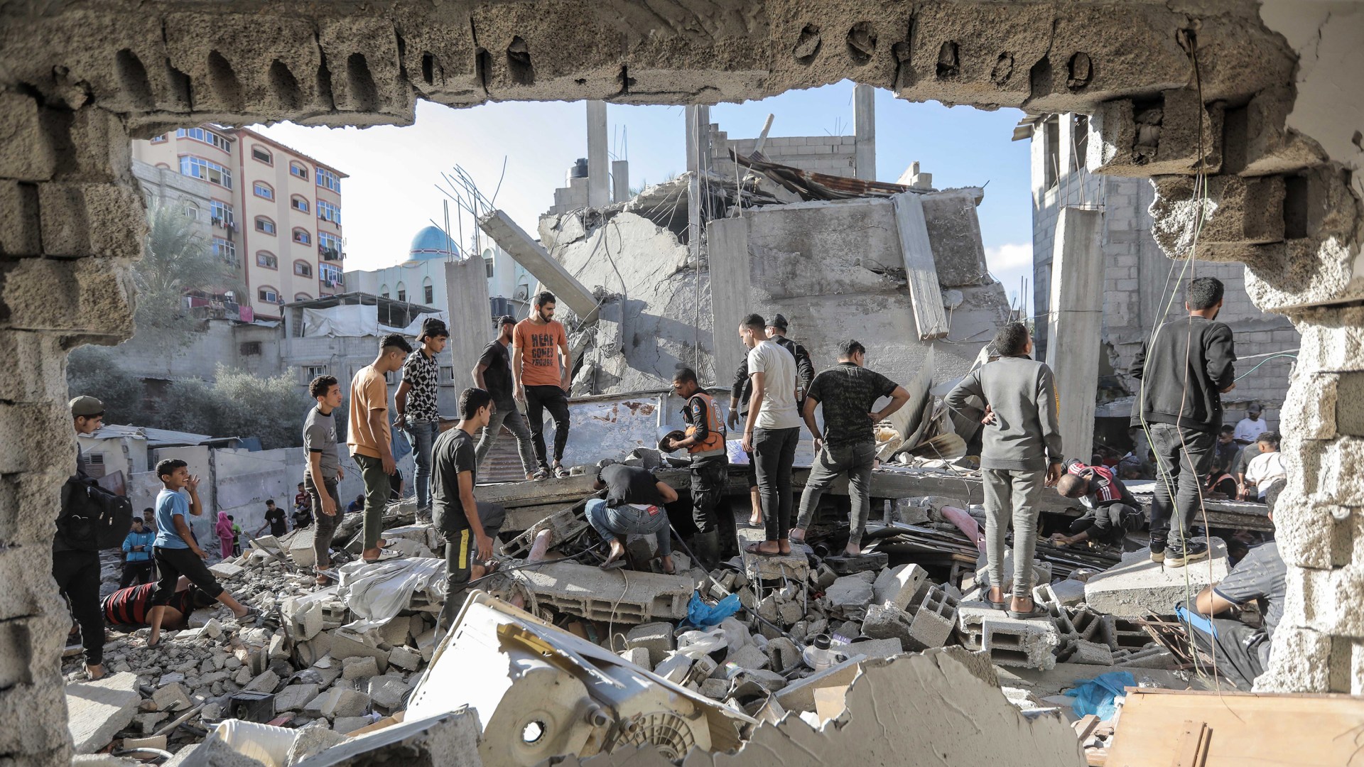 People search buildings destroyed during airstrikes in Gaza.