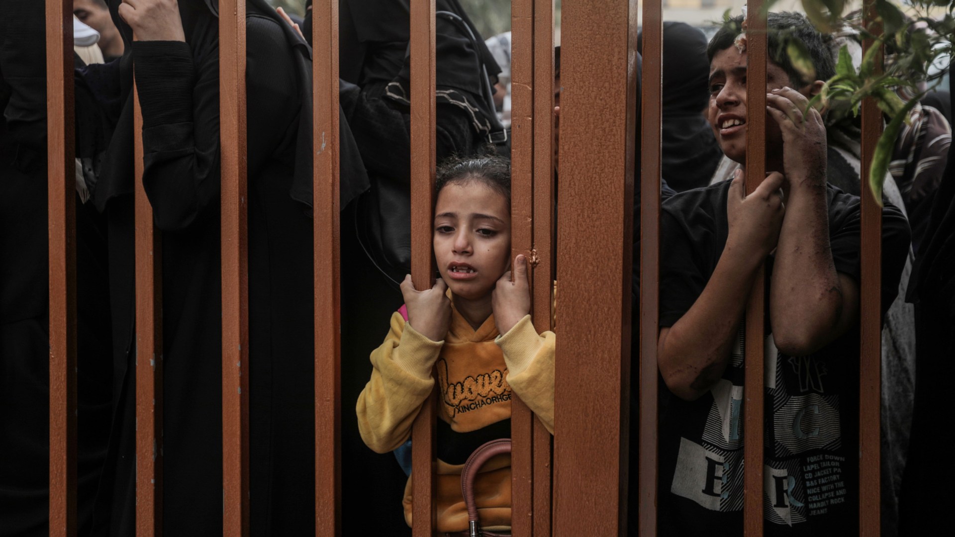 People mourn as they collect the bodies of Palestinians killed in Israeli raids.