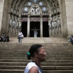 People walk past a Catholic church in Brazil.