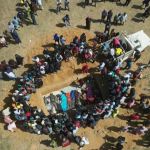 Families in Maiyanga bury in a mass grave relatives killed in deadly Christmas attacks conducted by armed groups in Nigeria's central Plateau State, on December 27, 2023.