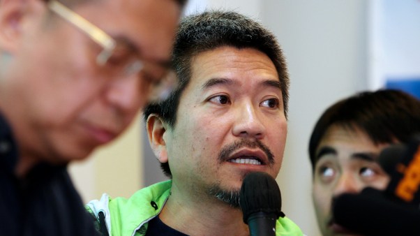 Principal of Christian Zheng Sheng College, Alman Chan Siu-cheuk (center), talks to media about the fraud allegations.