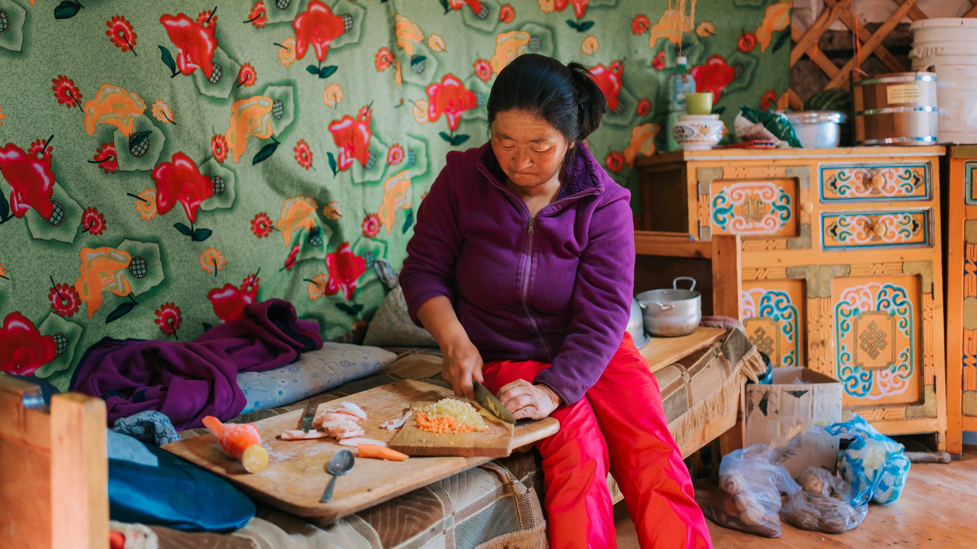 Mongolian woman preparing buuz, or meat dumplings, traditionally eaten during the Lunar New Year.