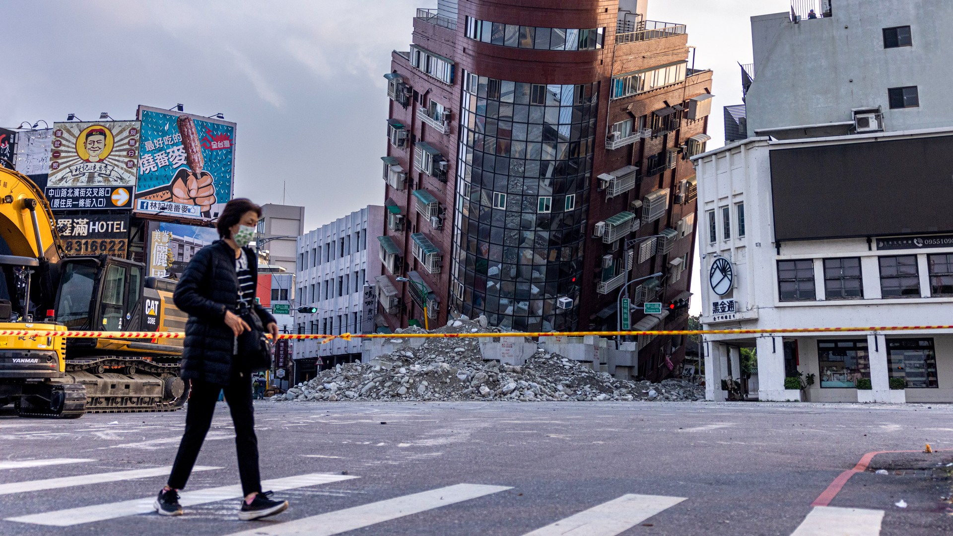 A person walks past an area of a damaged building following an earthquake in Taiwan.
