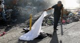 A man identifies a body after an overnight shooting in the Port-au-Prince suburb of Pétion-Ville in March.