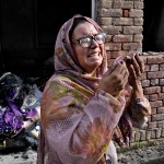 A Christian woman weeps after looking at her home vandalized by an angry Muslim mob in Pakistan.