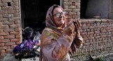 A Christian woman weeps after looking at her home vandalized by an angry Muslim mob in Pakistan.