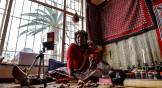 Gogo Kamo, a sangoma in Kempton Park, South Africa, uses bones, herbs, and the Bible to interpret a reading with an online client.