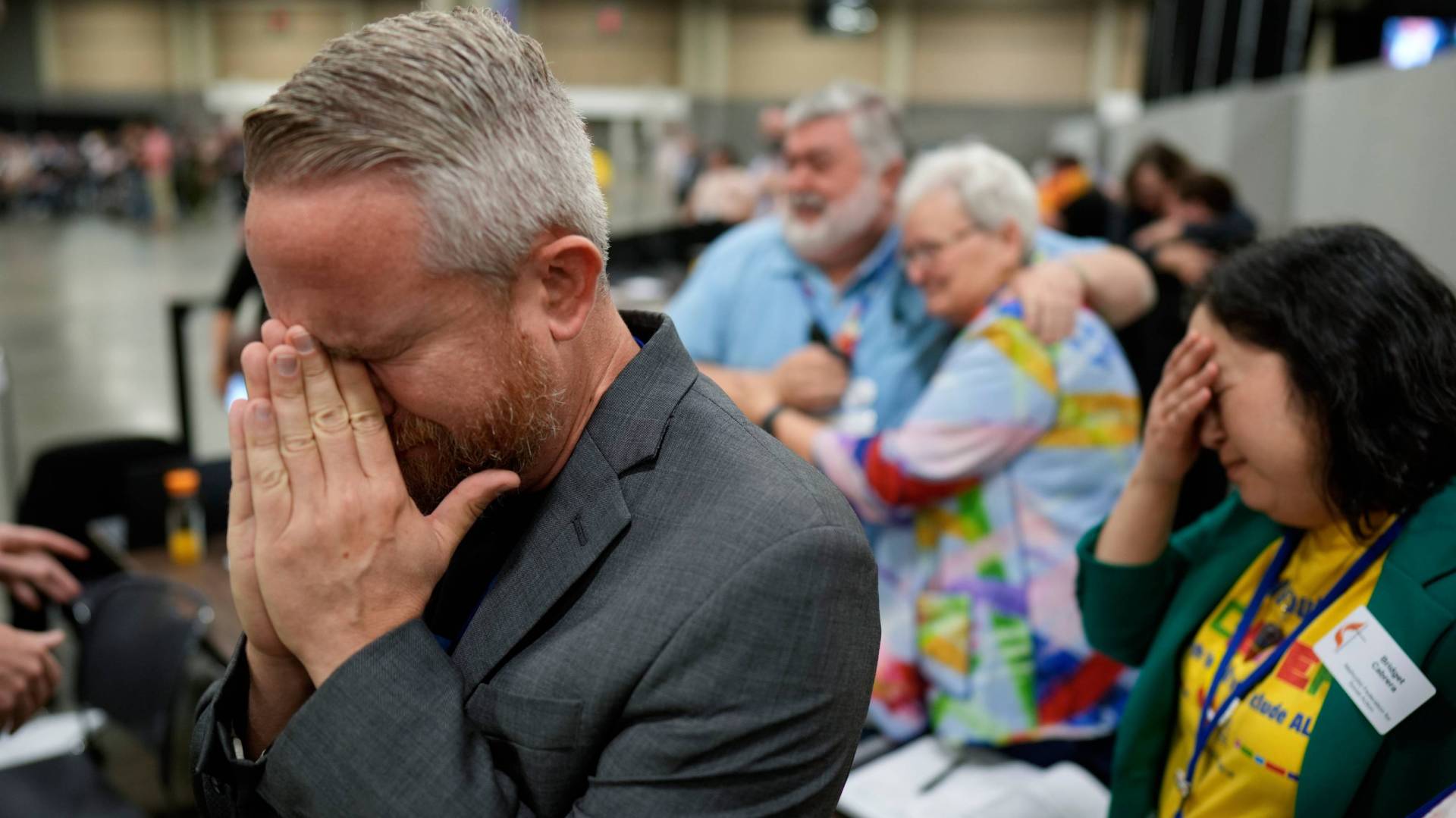 United Methodists react to the vote at their General Conference on Wednesday to repeal a ban on LGBTQ clergy.
