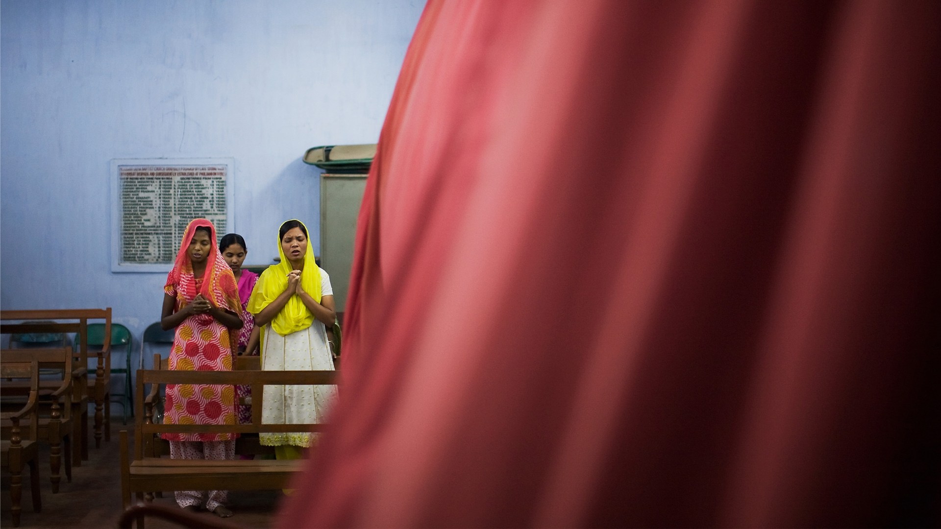 Christian women pray at an Easter service in Phulbaney, India.