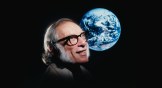 Noted science fiction author Isaac Asimov with a photo of the Earth from space.