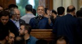Newly-elected Iranian President Masoud Pezeshkian (center) speaks during a visit to a shrine.