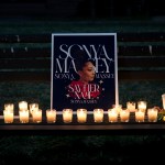 Mourners bring candles to a vigil in honor of Sonya Massey.