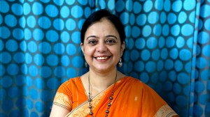 Surinder Kaur in front of a blue dotted cloth