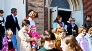 People in the 1970s walking out of a church
