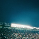 A stadium full of people at night with bright lights