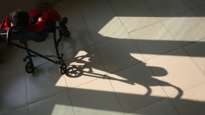 A boy basks in the sunlight from a window at an orphanage for disabled children in China