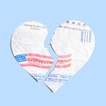 A voting ballot in the shape of a heart torn in half.
