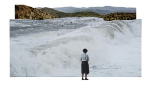 Mountains cutout in the background with stormy waves on top of it and a woman standing looking