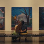 Andra Day as Aisha and André Holland as Tarrell sitting and looking at paintings in Exhibiting Forgiveness