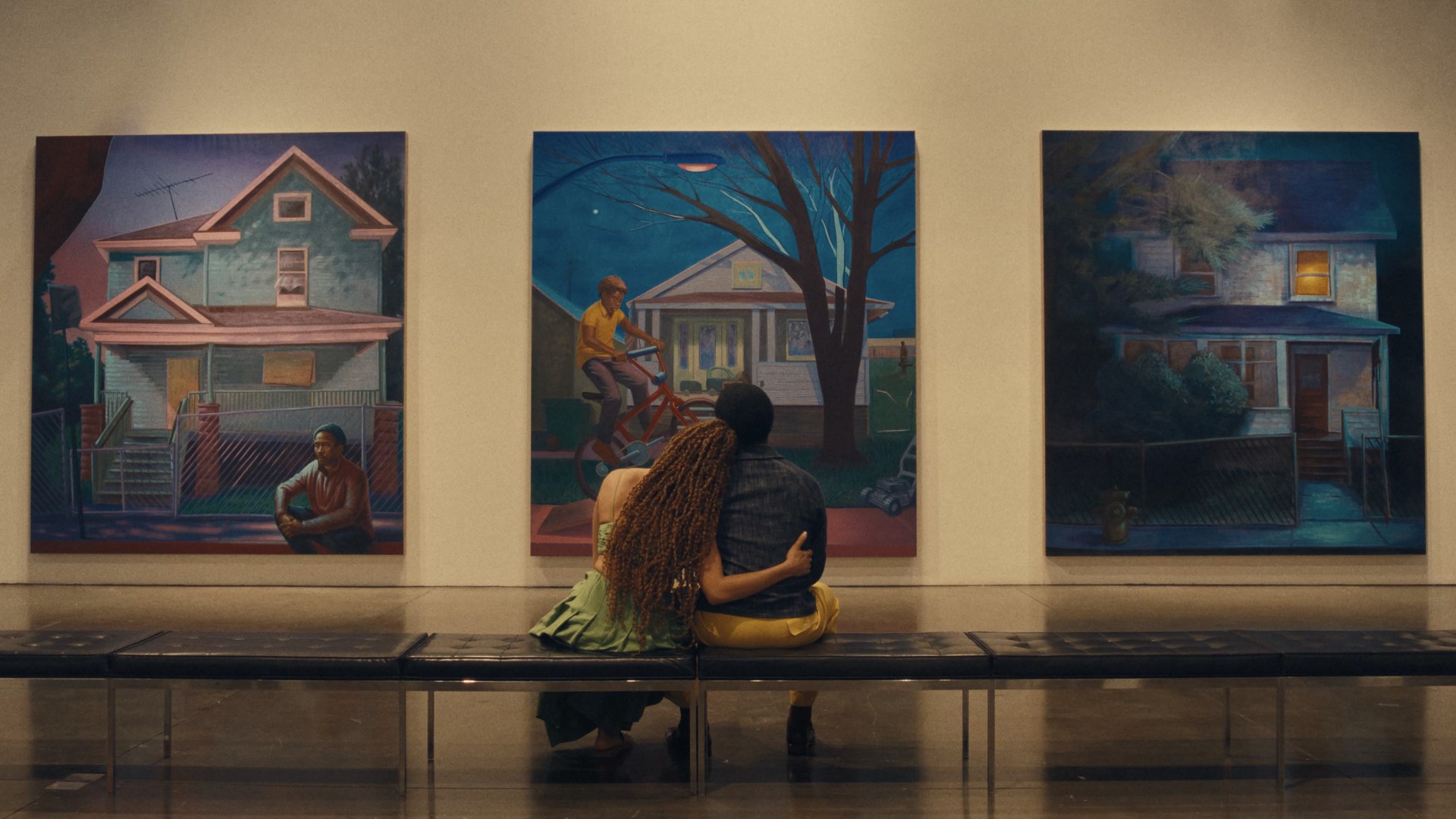 Andra Day as Aisha and André Holland as Tarrell sitting and looking at paintings in Exhibiting Forgiveness
