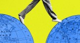 A person's feet stepping over a gap in between two maps of the earth.
