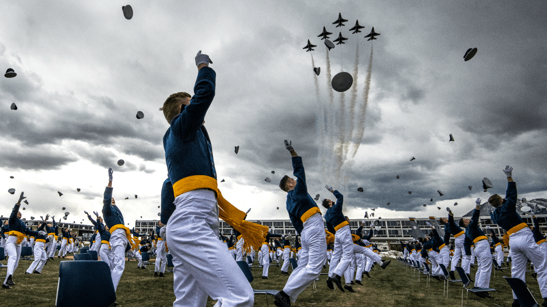 Air Force cadets entering Space Force cheer throw hats air graduation