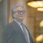 Bill Hwang, founder of Archegos Capital Management, arrives at federal court in New York, US, on Wednesday, Nov. 20, 2024. He is a grey-haired man wearing thick glasses and a suit with a purple tie.