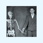A skeleton holding hands with a man