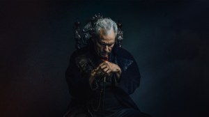 Scrooge sitting on a chair in a dark room from the play A Christmas Carol at Rabbit Room