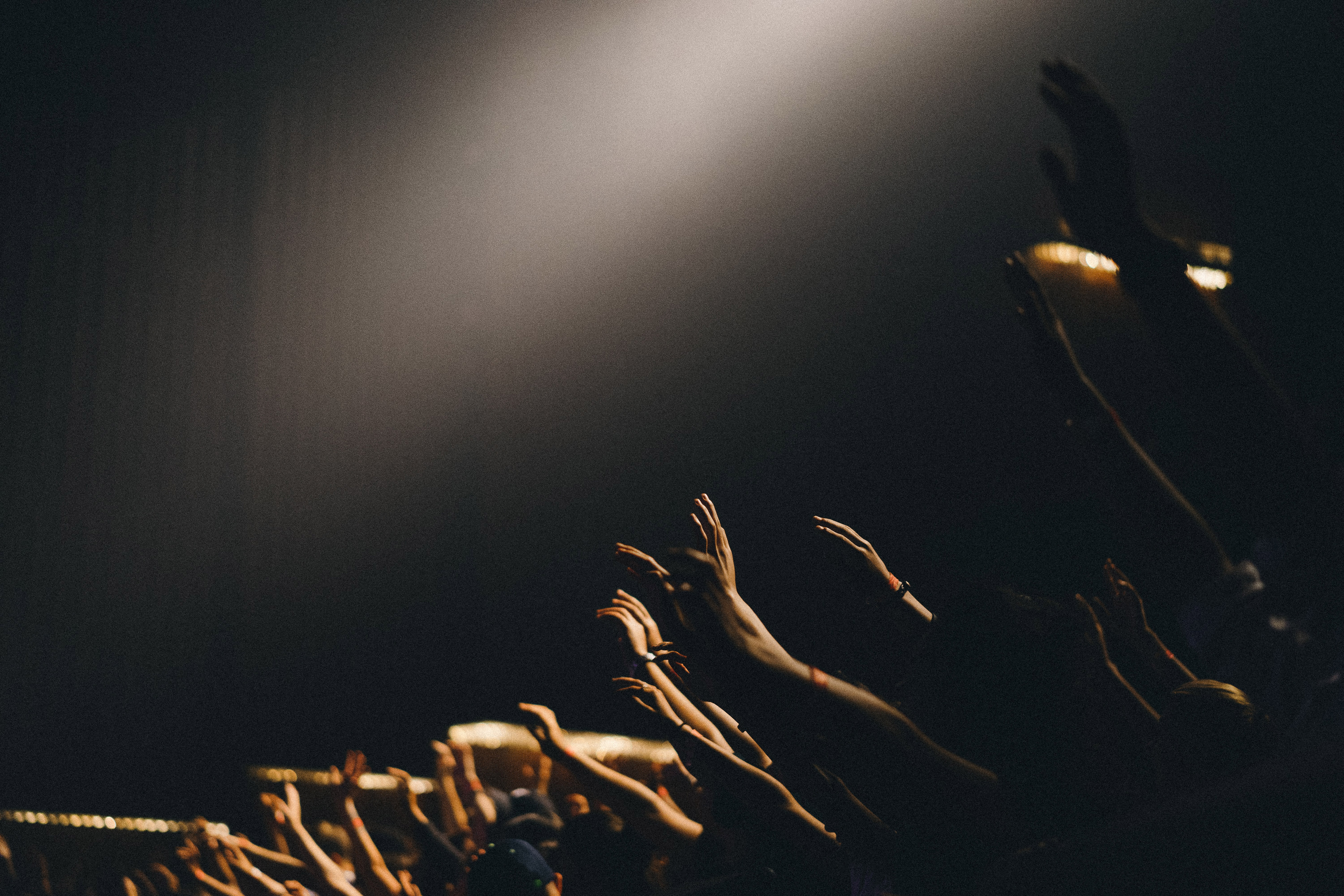 A photo of hands raised in worship